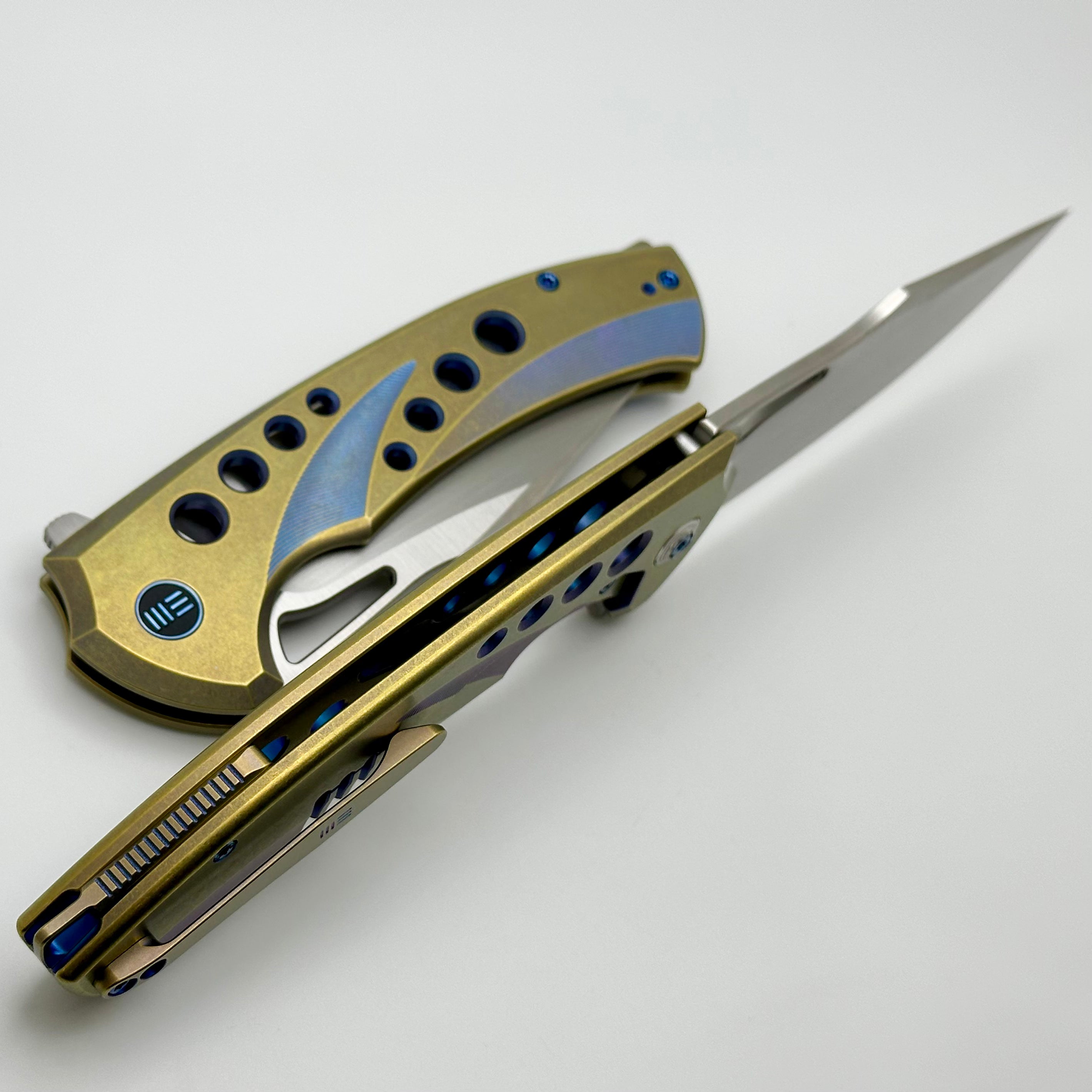 Premium WE Knife Swiftfin: Golden/Blue Titanium Handles with Blue Holes & Hand Satin 20CV Blade WE23051-4