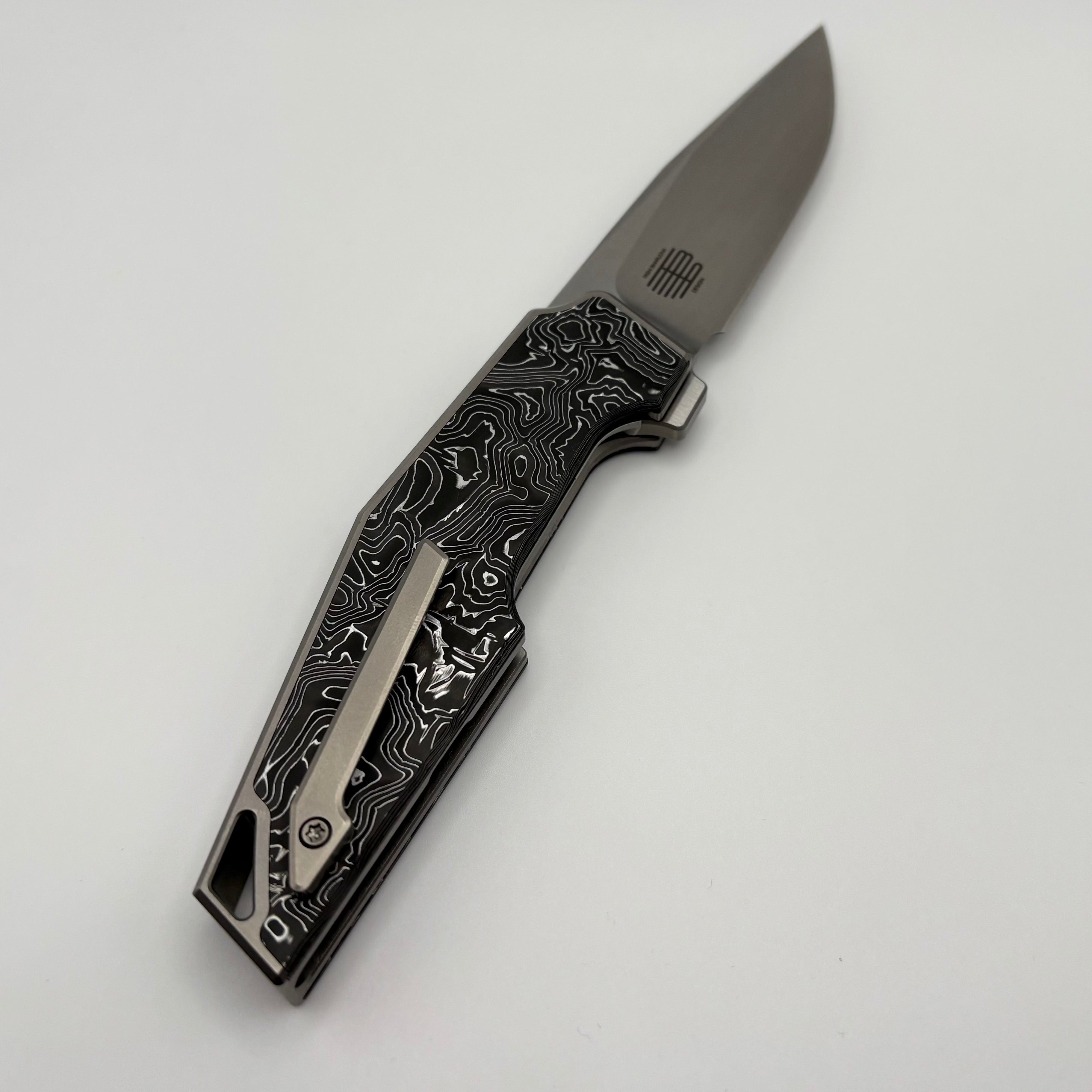 Premium Pre-Owned We Knife OAO Flipper - Titanium Handle with Carbon Fiber Inlays & 20CV Blade